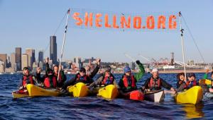 This April 17, 2015 photo shows a group of kayakers letting out a yell after successfully pulling up a protest sign as they practice for an upcoming demonstration against Arctic oil drilling, in Elliott Bay in Seattle. Seattle Mayor Ed Murray said Monday, May 4, 2015, the Port of Seattle can't host Royal Dutch Shell's offshore Arctic oil-drilling fleet unless it gets a new land-use permit. Shell has been hoping to base its fleet at the port's Terminal 5, near where protesters plan a mass kayak protest later this month. (AP Photo/Elaine Thompson)