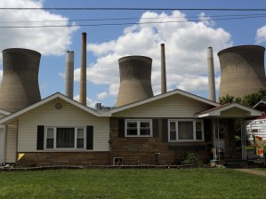 The John Amos coal-fired power plant is seen behind a home in Poca